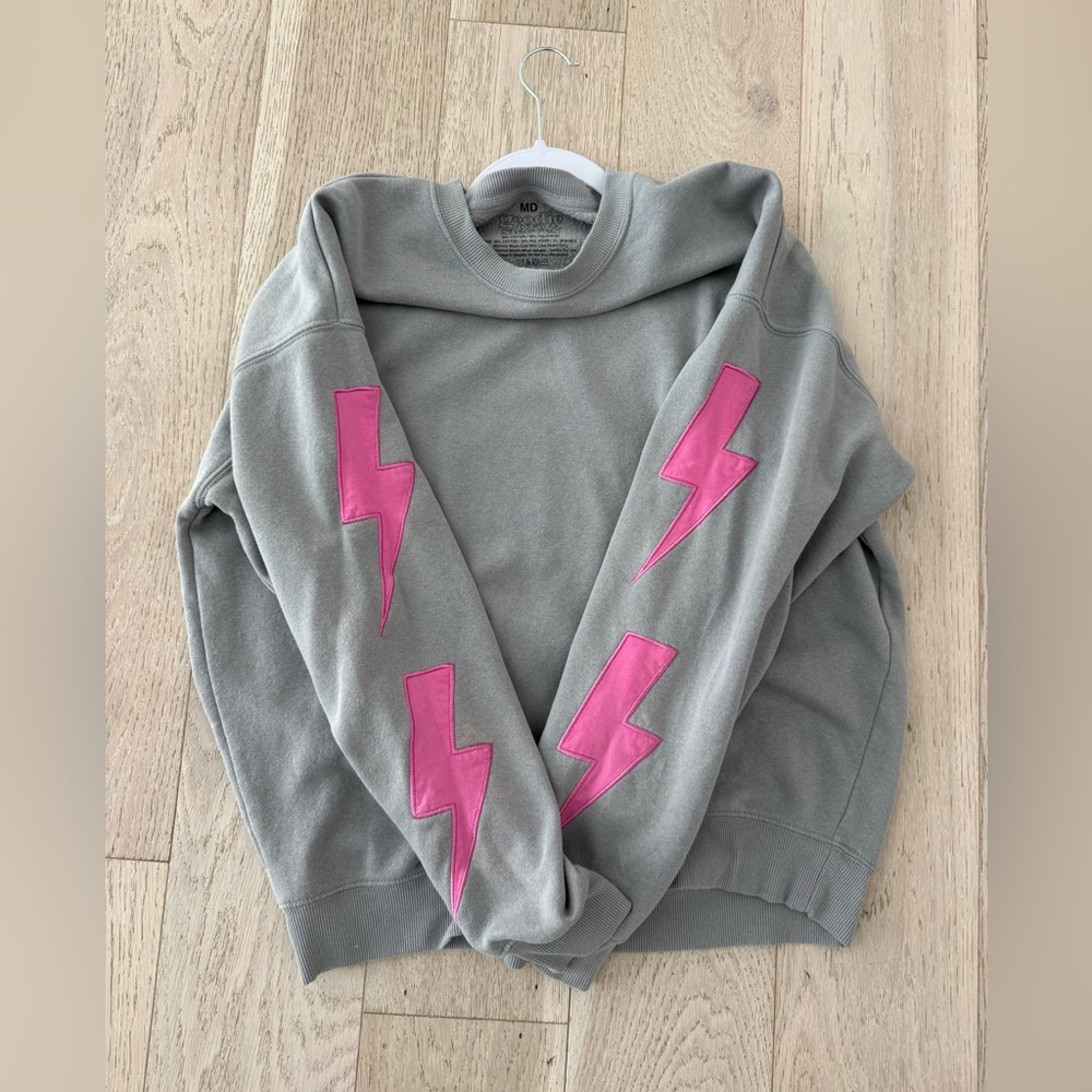 Goodie Two Sleeves - Medium-Gray sweatshirt with Pink Lightning Bolts on sleeves